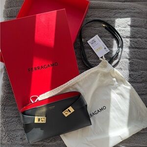 Woman, black and red Ferragamo clutch/purse/wallet